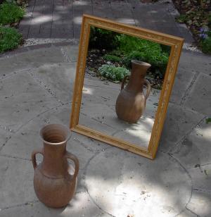 A mirror mounted on a wall indoors.