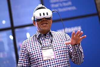 A person wearing a virtual reality headset at a technology event.
