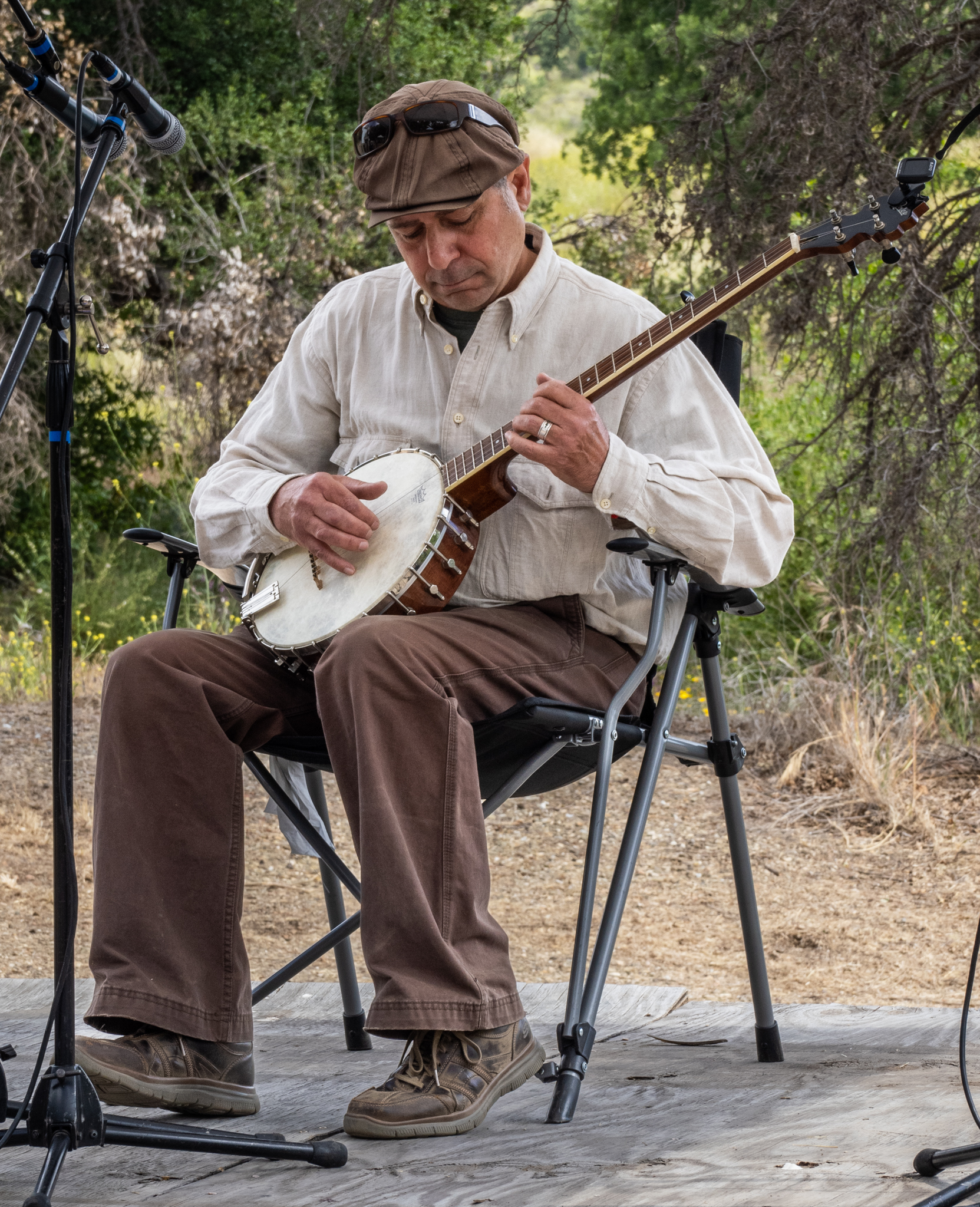 Close-up of a banjo being played with a right hand picking the strings